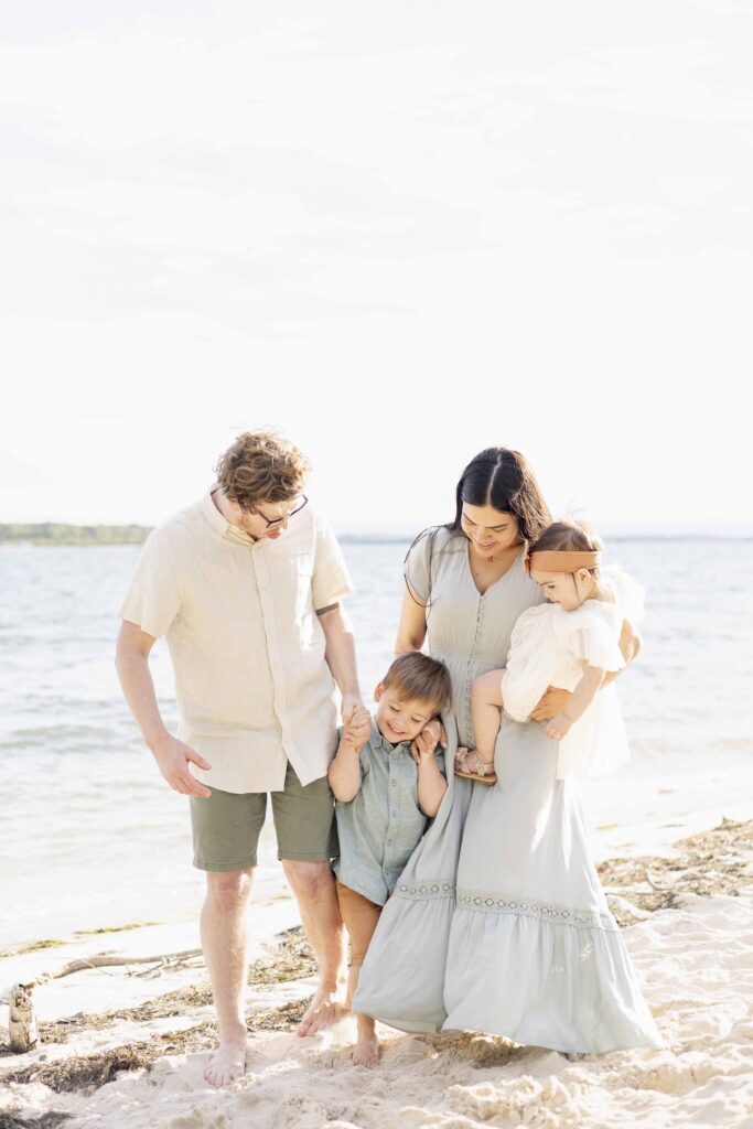 Joyful photo of  a family of four on the beach on Bribie Island | Sharon Joseph Photography | Outdoor family photos