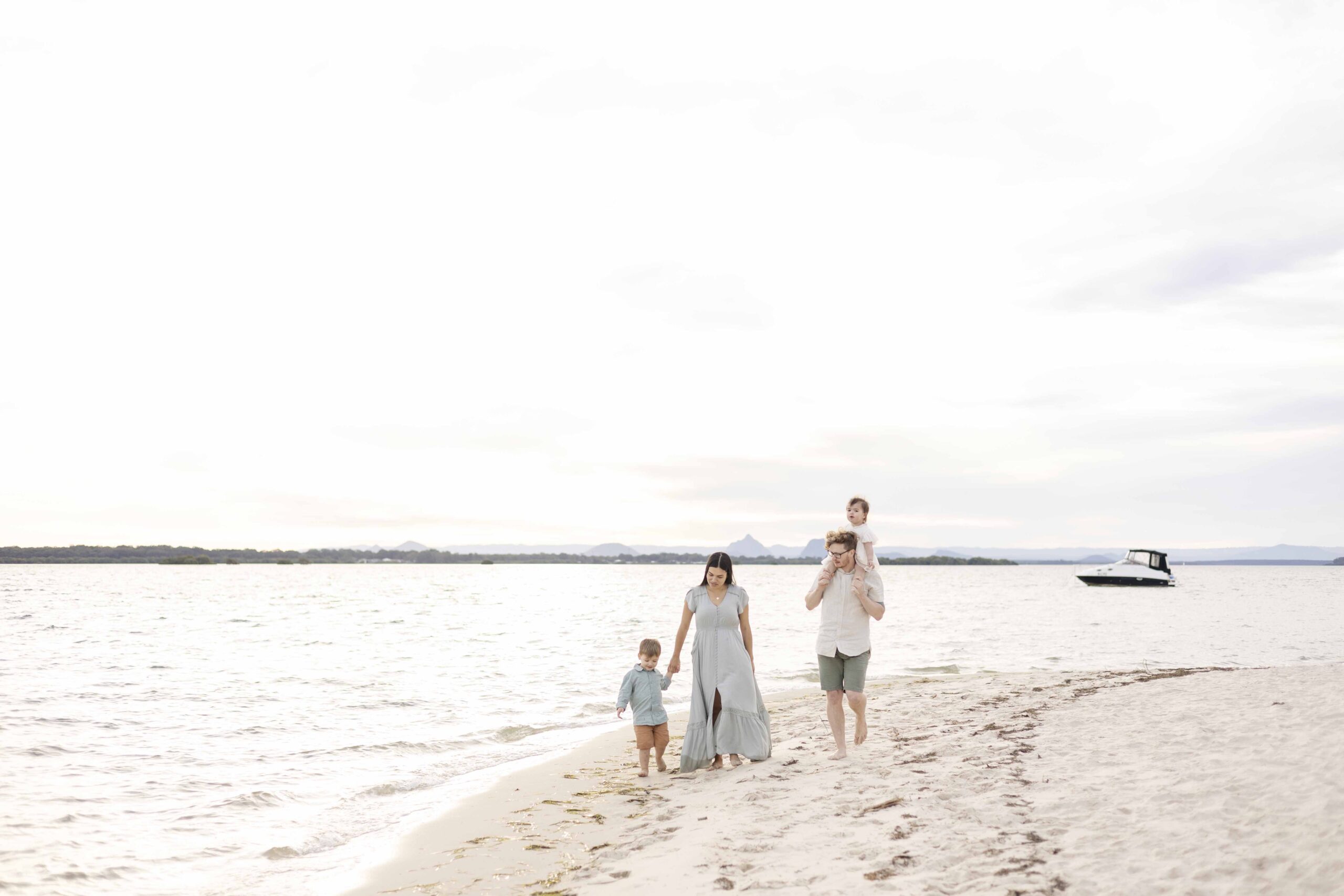 Family Portraits on Bribie Island. Family of four enjoying a leisurely walk on the beach | Sharon Joseph Photography | North Brisbane Family Photographer.