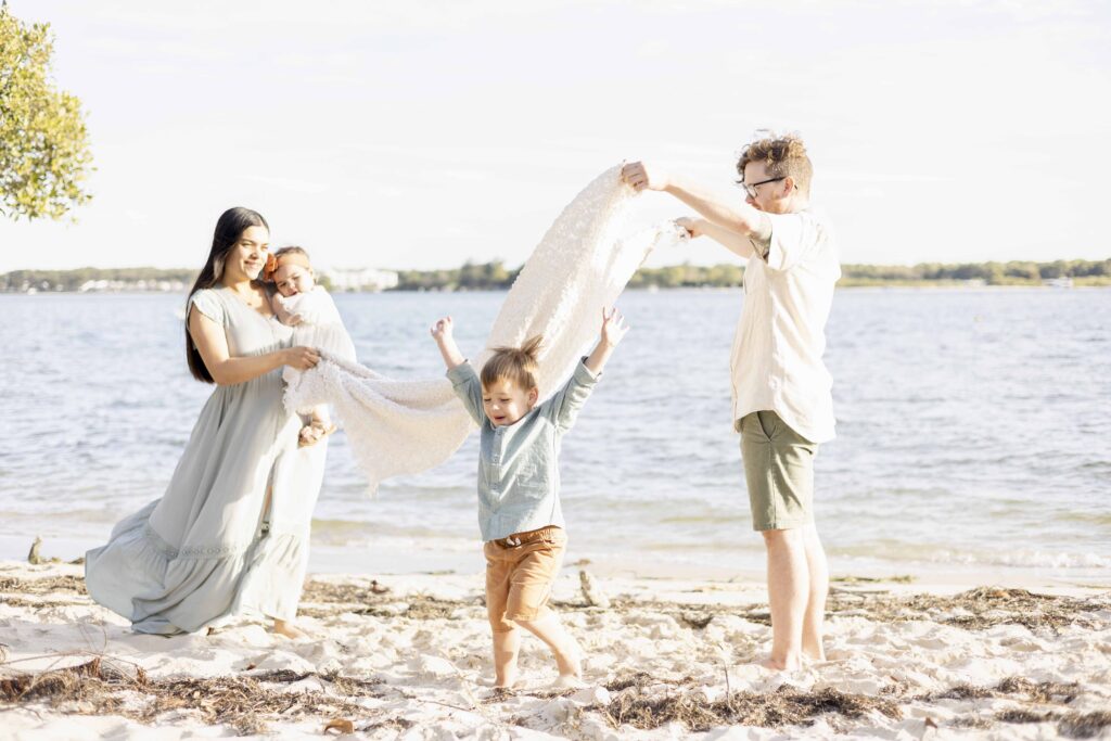 Fun family photoshoots Brisbane | Family playing on beach in Brisbane | Sharon Joseph Photography