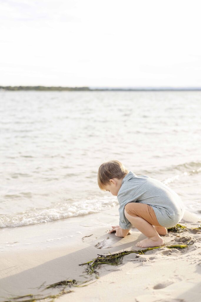 Brisbane kids portraits | Young boy playing with the sand on the beach at Bribie island, Moreton bay, Queensland | By Sharon Joseph Photography |