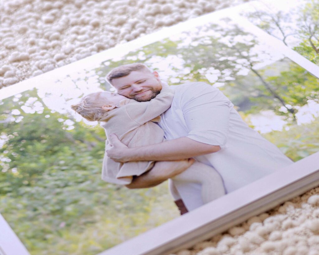 An album page of a little girl kissing her dad's cheek. Sharon Joseph Photography, Brisbane Family Photos.