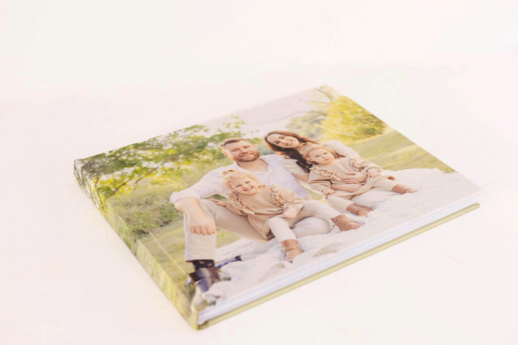 Photo Album with a Family of four on the cover. There's dad, mum and two little girls. Sharon Joseph Photography, Brisbane Family Portraits