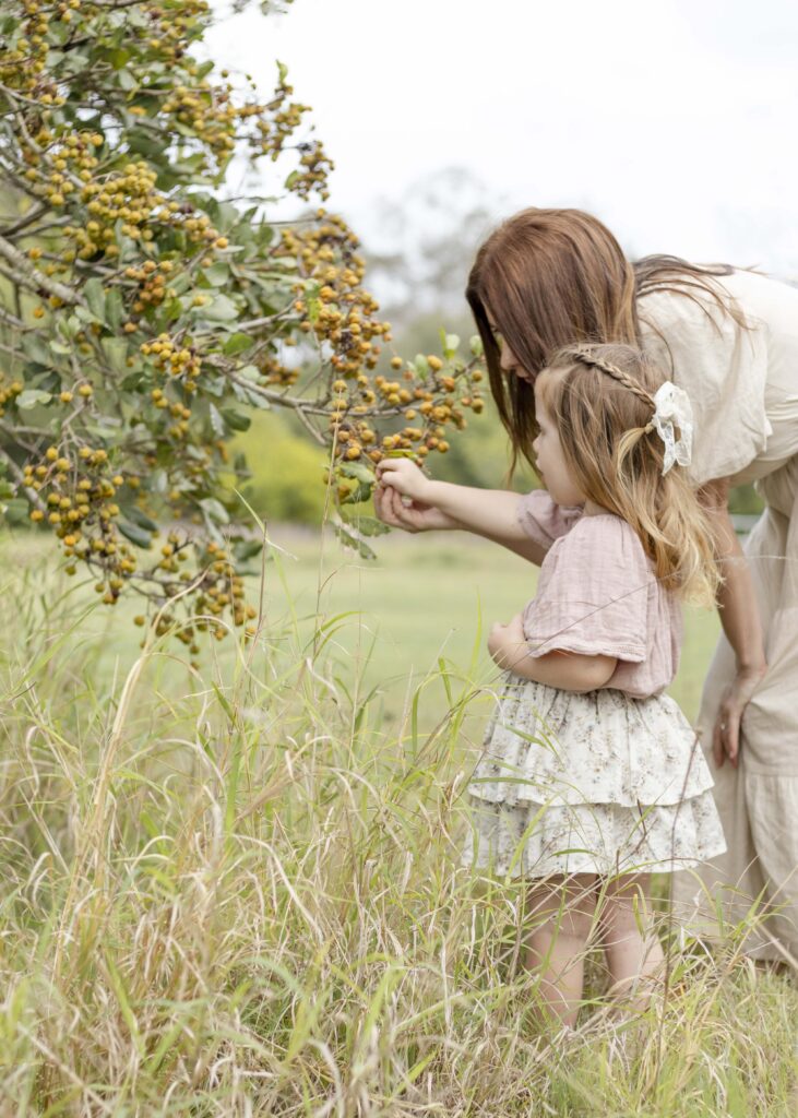 A little girl picking "pumpkins" from a tree in Brisbane, Australia. 