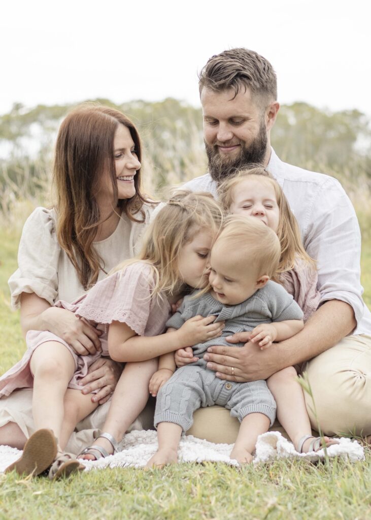 Family of five enjoying a family cuddle. Brisbane Family Photography by Sharon Joseph