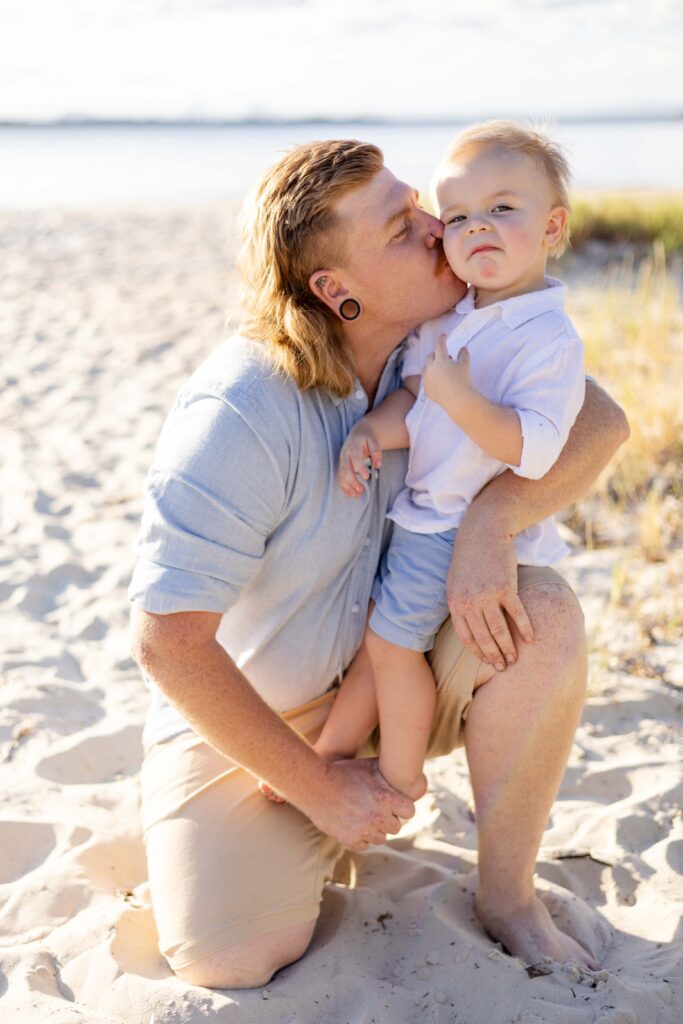 Dad giving his son a kiss on the cheek. Brisbane family photography.