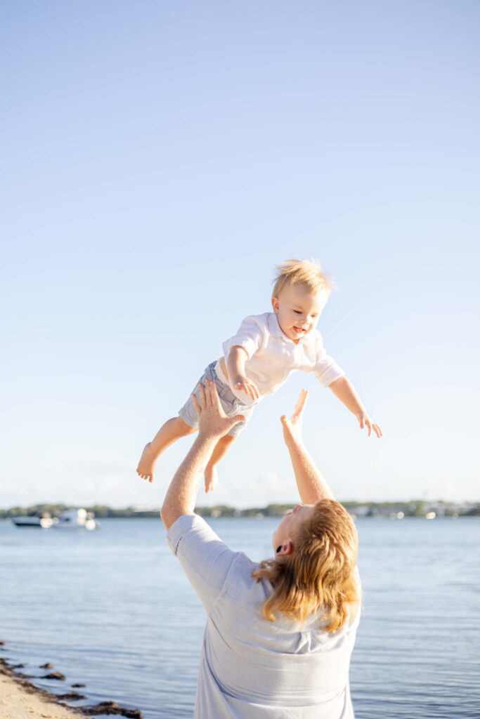 Dad throwing his boy up in the air. Brisbane family photography.