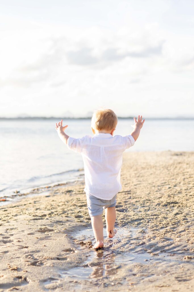 Toddler enjoying the beach. Brisbane family photography.