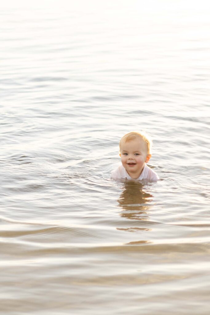 Little boy swimimg at the beach. 