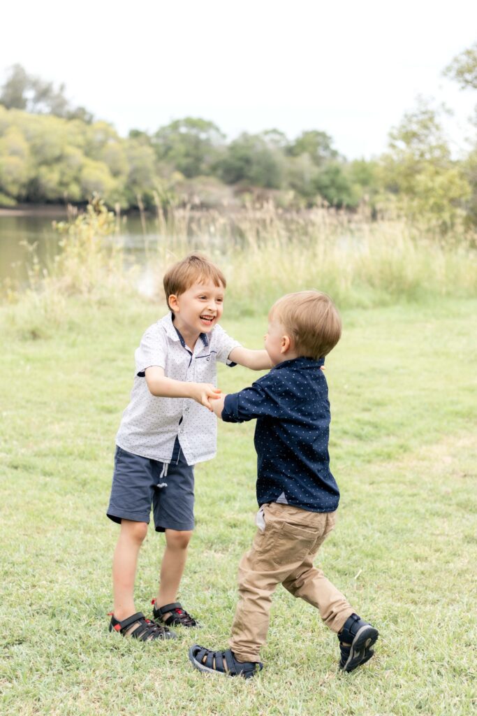 Two young boys happily wrestling