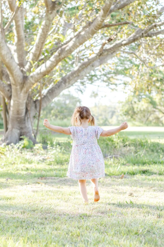 A little girl frolicking in the park