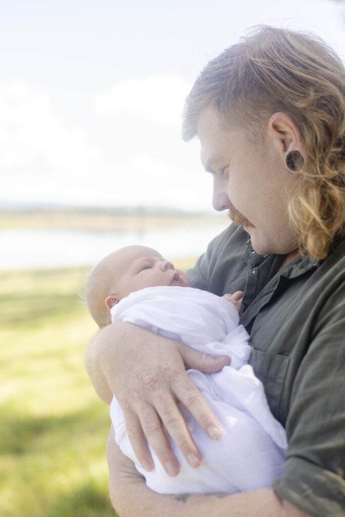 Dad and newborn, during outdoor morning photoshoot in Brisbane
