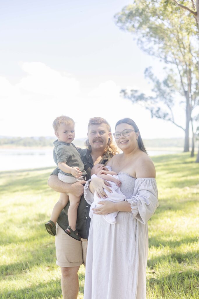Family portrait of family of four, taken at an outdoor morning photoshoot in Brisbane. by Sharon Joseph Photography.