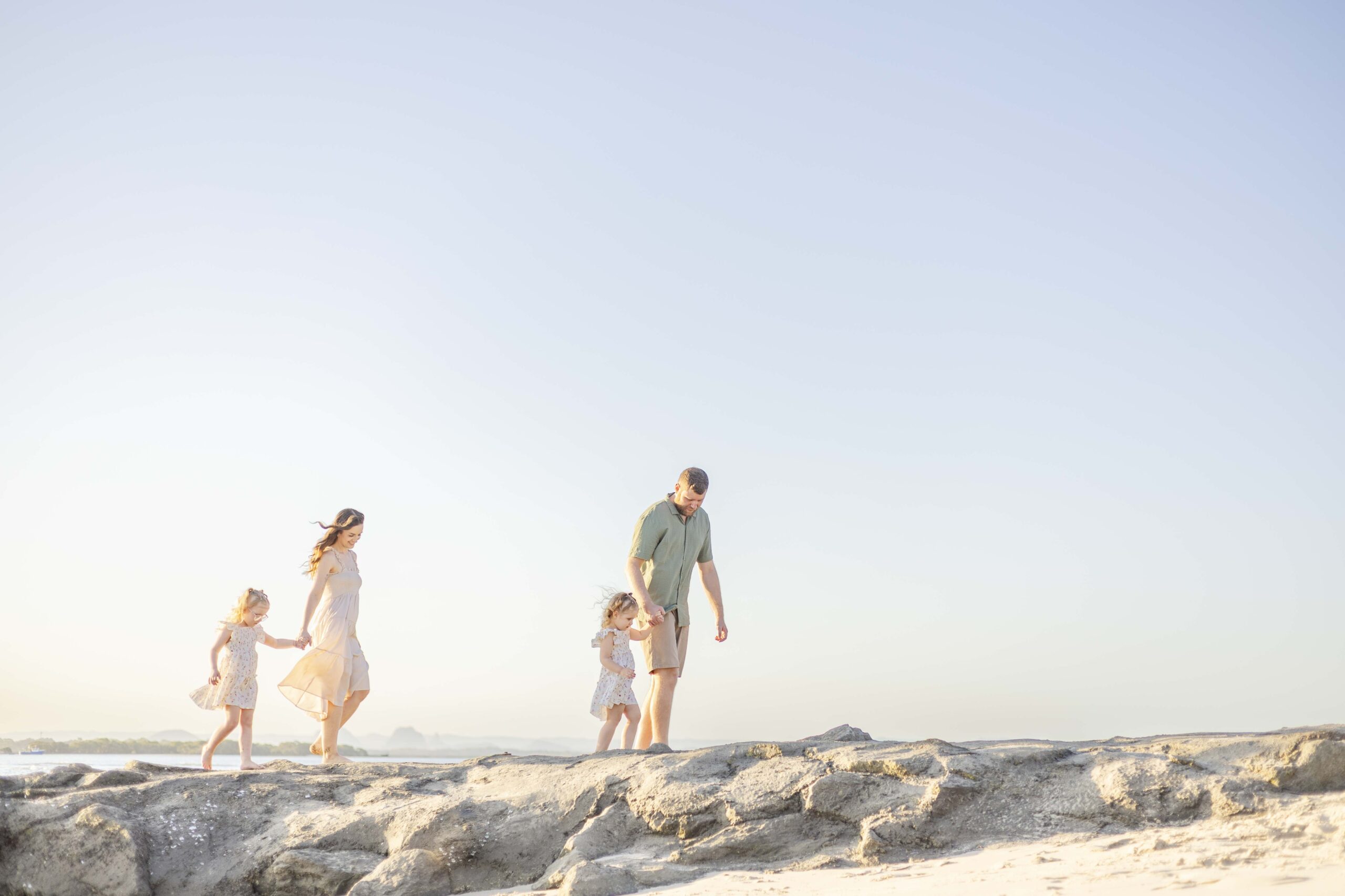 Family photo at beautiful Brisbane Beach. By Sharon Joseph Photography.