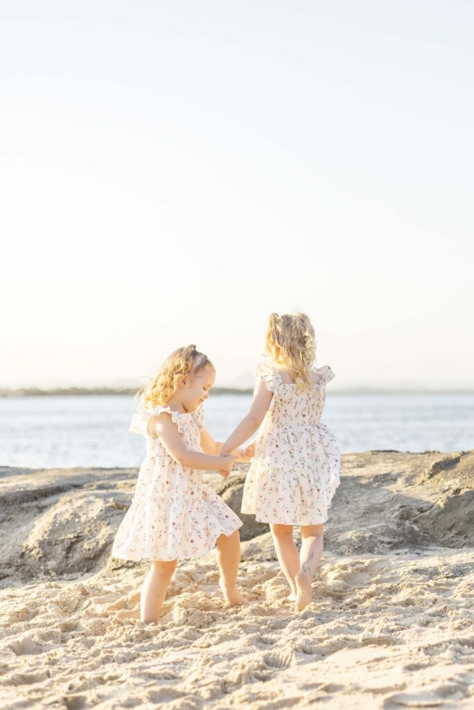 Fun sisters photo. Family photo at beautiful Brisbane Beach. By Sharon Joseph Photography.