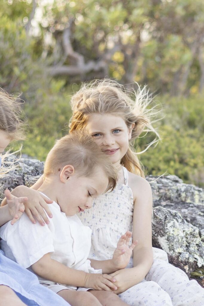 Cute brother-sister moment captured during a family photography session by Sharon Joseph Photography