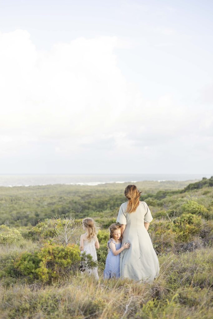 Young family enjoying ocean views from the top of Emu Mountain Summit Walk, during photoshoot by Sharon Joseph