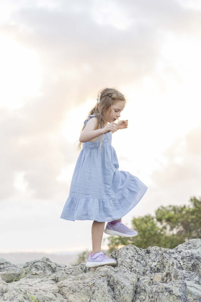 Girl climbing rock at Emu Mountain