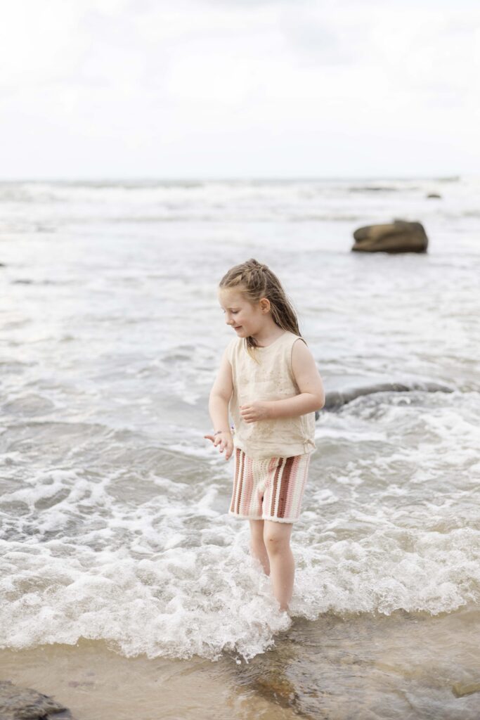 Little girl splashing in the waves