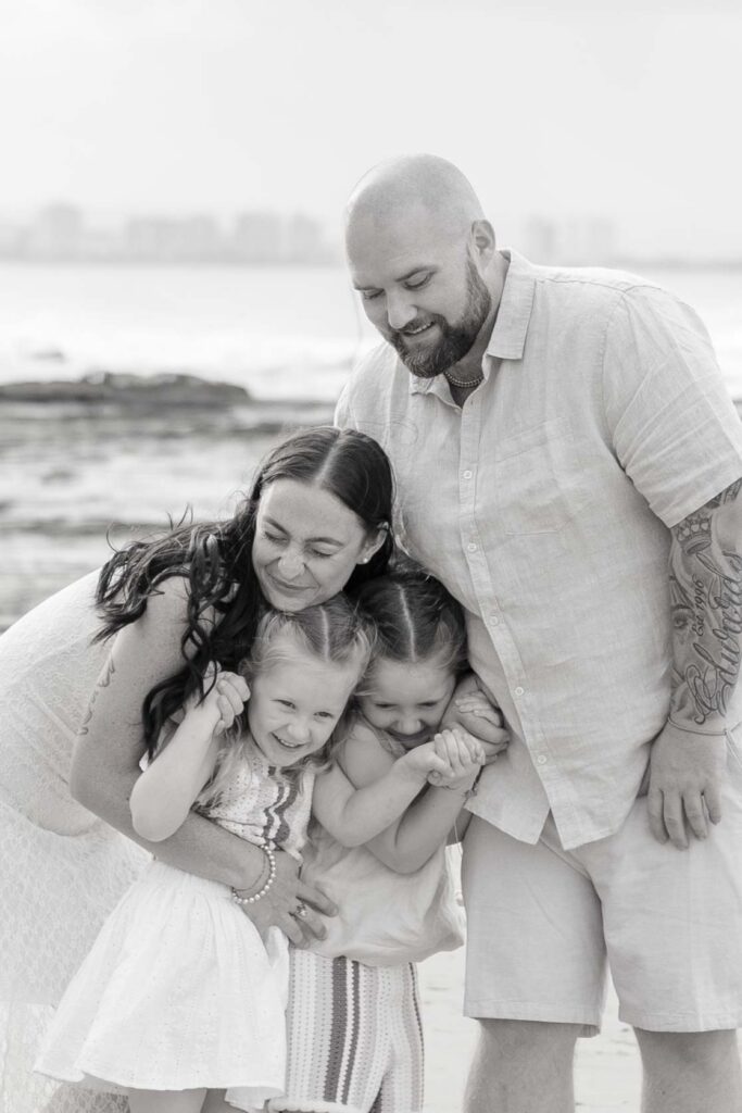 A cute family hug at a photoshoot at Point Cartwright on Sunshine Coast