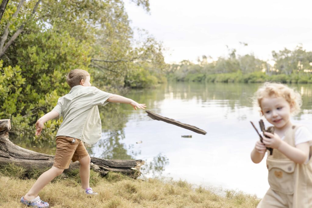 Little boys throwing sticks into a river at their relaxed family photo session in North Brisbane.
What if kids don't cooperate during family photos? It's okay!