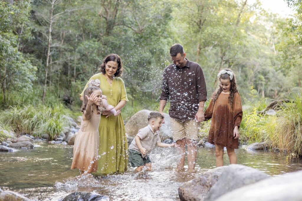 Family of six splashing in the creek, at their fun family photoshoot in Brisbane. What if your kids don't cooperate during family photos? That's totally okay!