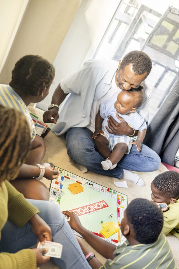 family playing Monopoly during their family photoshoot at their home in Brisbane